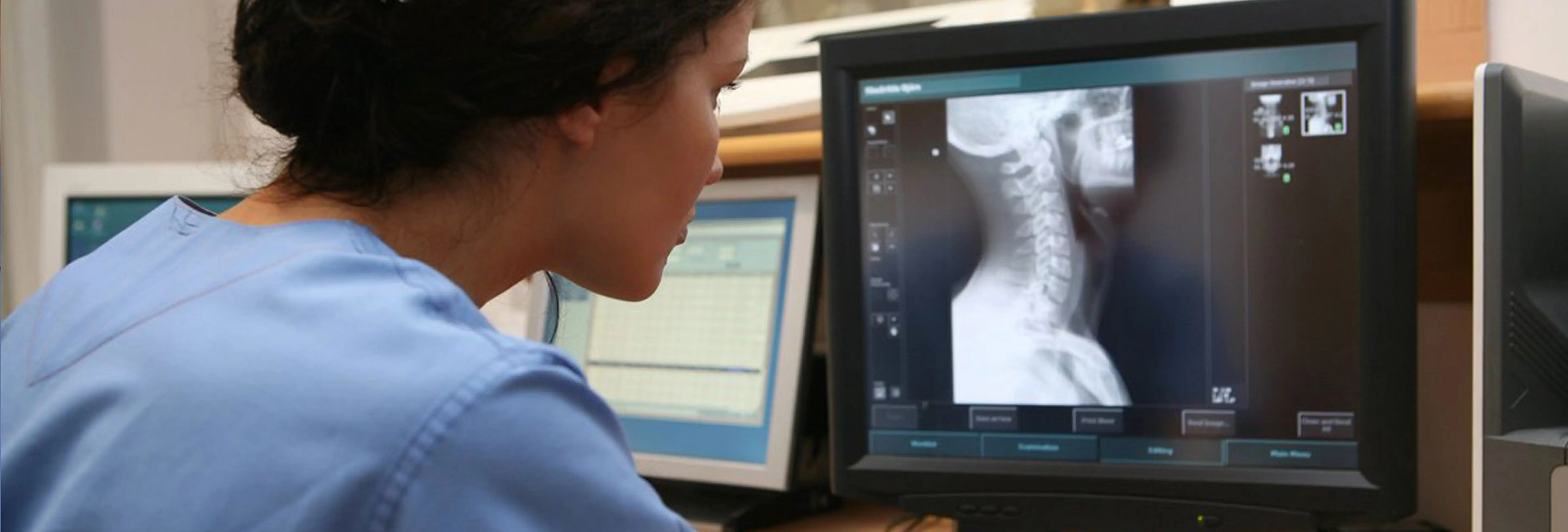 Medical professional examining X-ray scans